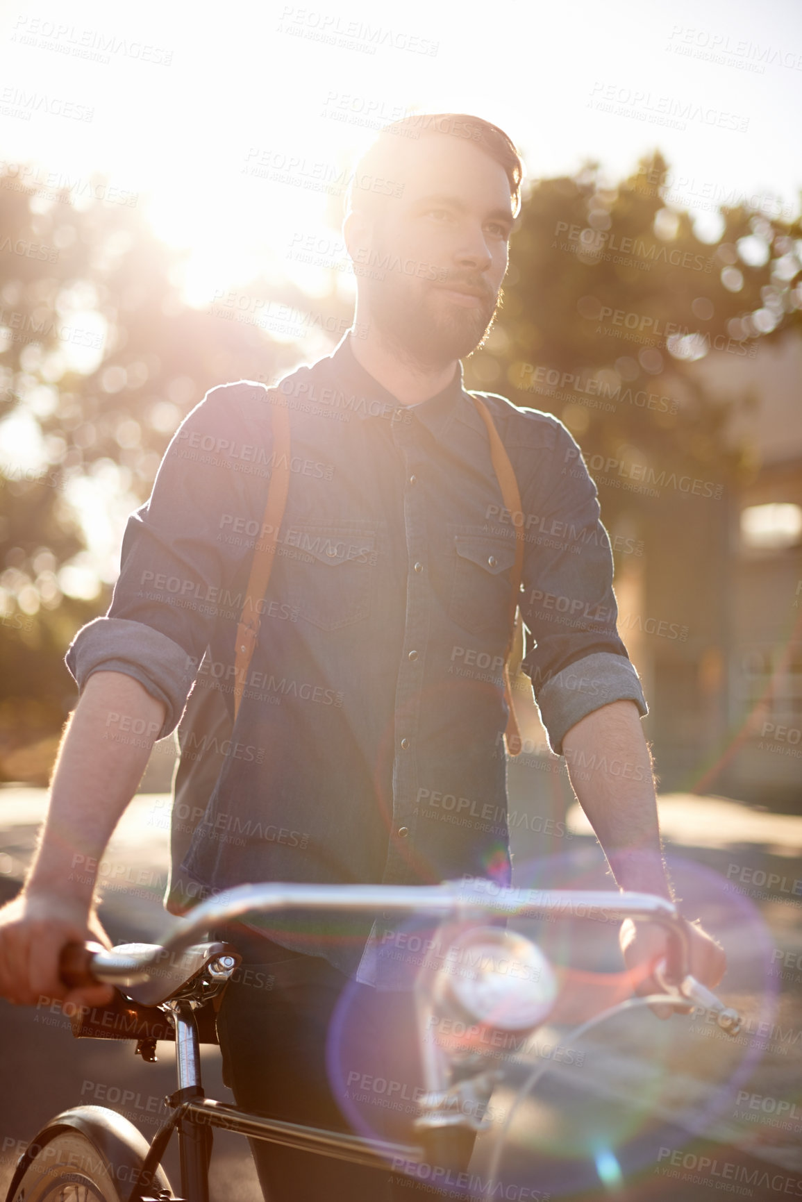 Buy stock photo Walking, transport and man in road with bicycle for exercise, commute and cycling in morning. Travel, lens flare and male cyclist with bike for eco friendly traveling, carbon footprint and journey