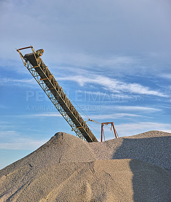 Buy stock photo Crane, sand and machine with blue sky at construction site for building of foundation, bricklaying and landscape project. Closeup, industrial equipment and vehicle for business, ground work and job
