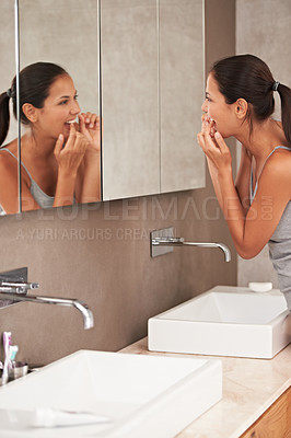 Buy stock photo Mirror, bathroom and woman with floss for cleaning, oral hygiene and dental care in home. Morning routine, healthcare and person for whitening, wellness and grooming for gum disease and fresh breath
