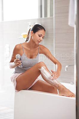 Buy stock photo Skincare, foam and woman shaving legs in a bathroom for hair removal, hygiene or smooth skin in her home. Beauty, product and female person with gel, soap or bottle for cosmetic, wellness or routine