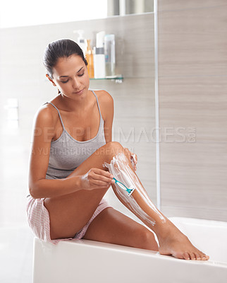 Buy stock photo Skincare, razor and woman shaving legs in a bathroom for hair removal, hygiene or smooth skin in her home. Beauty, blade and female person with foam, soap or product for cosmetic, wellness or routine