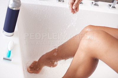 Buy stock photo Skincare, bathtub and woman shaving legs in a bathroom with razor, product or cosmetic bottle closeup. Water, feet and female person in a house hair removal, beauty or morning, cleaning or routine