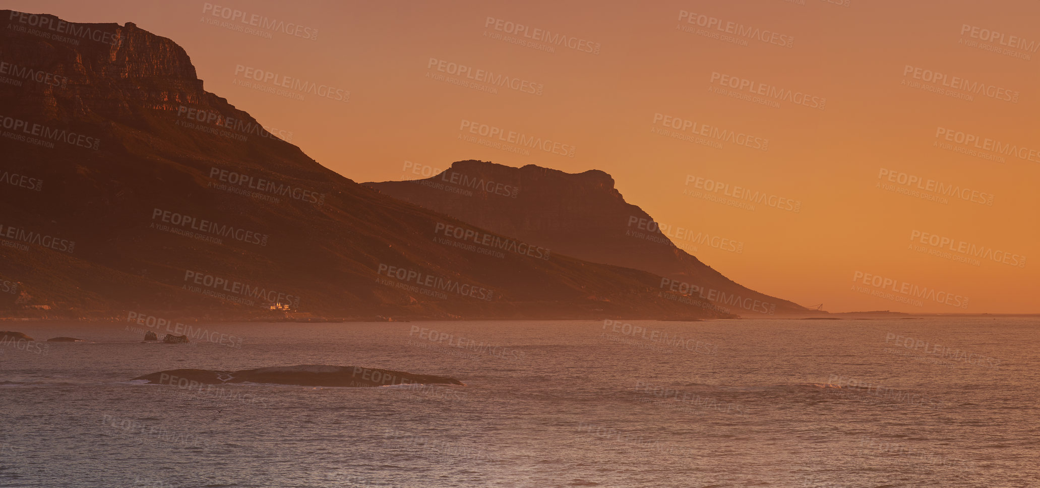 Buy stock photo Sea, sunset and mountain on island, paradise and tourist destination for summer vacation in nature. Rocks, ocean and color in sky in cape town, peace and outdoor travel of sustainable environment