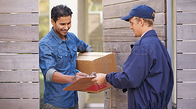 Buy stock photo A friendly delivery man delivering a package to a home