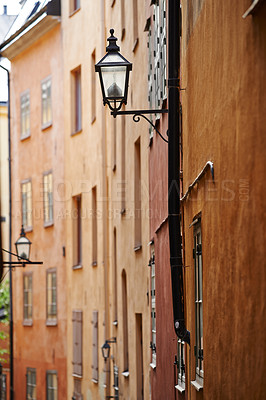 Buy stock photo Travel, architecture and lamp in vintage alley of old town with history, culture or holiday destination in Sweden. Vacation, buildings and antique lantern in Stockholm with retro light ancient city