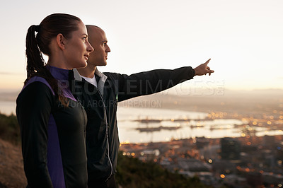 Buy stock photo Exercise, nature and couple with hand pointing to sunset, city view or fitness vision. Health, training and sports people outside planning running route, workout or speed target together at sunrise