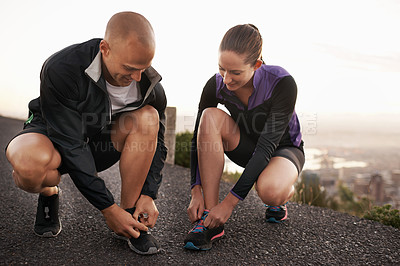 Buy stock photo Fitness, shoes and couple in a road for running, training or morning cardio run in nature together. Sneakers, shoelace and sports runner people outdoor for marathon, routine or performance workout