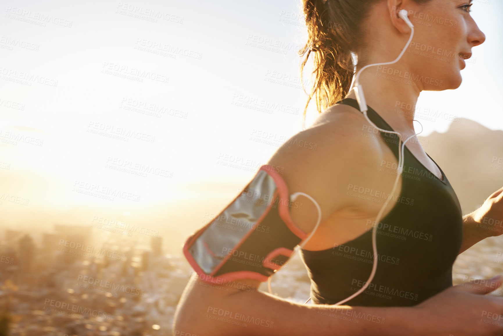 Buy stock photo Woman, running and listening to music with earphones for workout, training or outdoor exercise. Young female person or runner with smile and headphones for audio streaming or cardio on mockup space