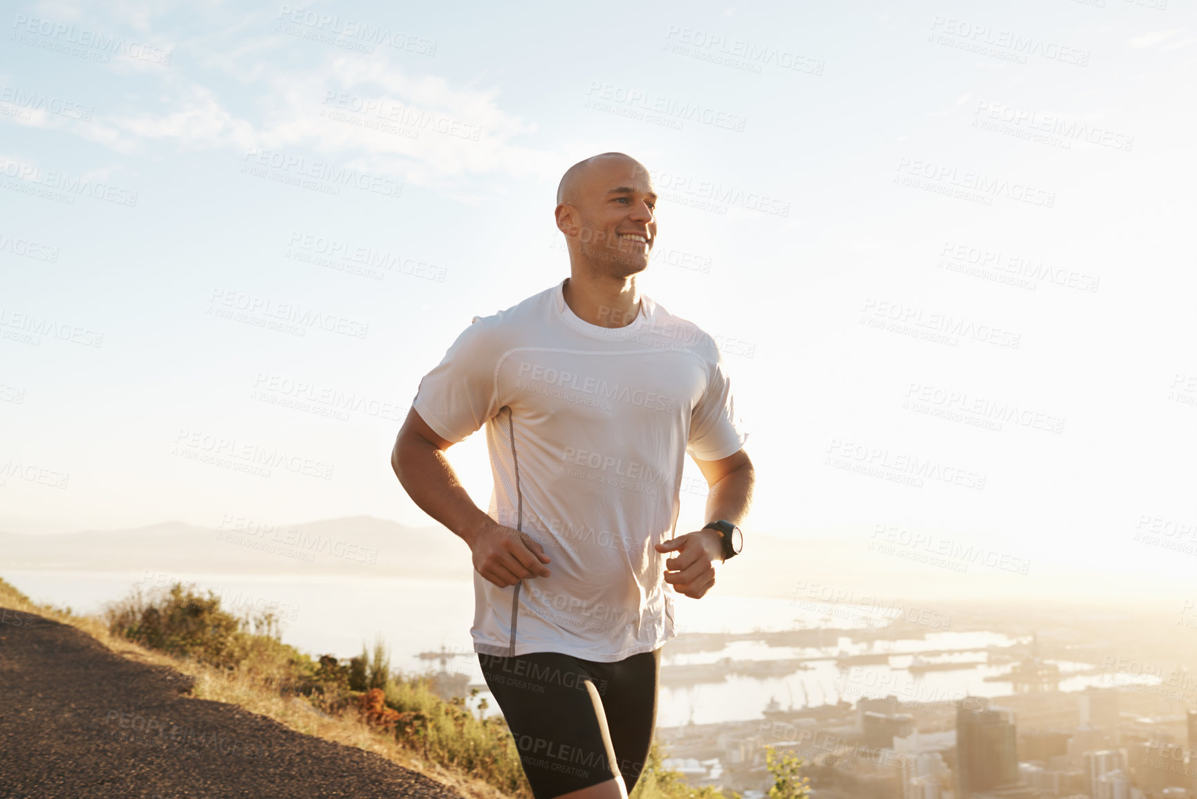 Buy stock photo Shot of a young runner training outdoors