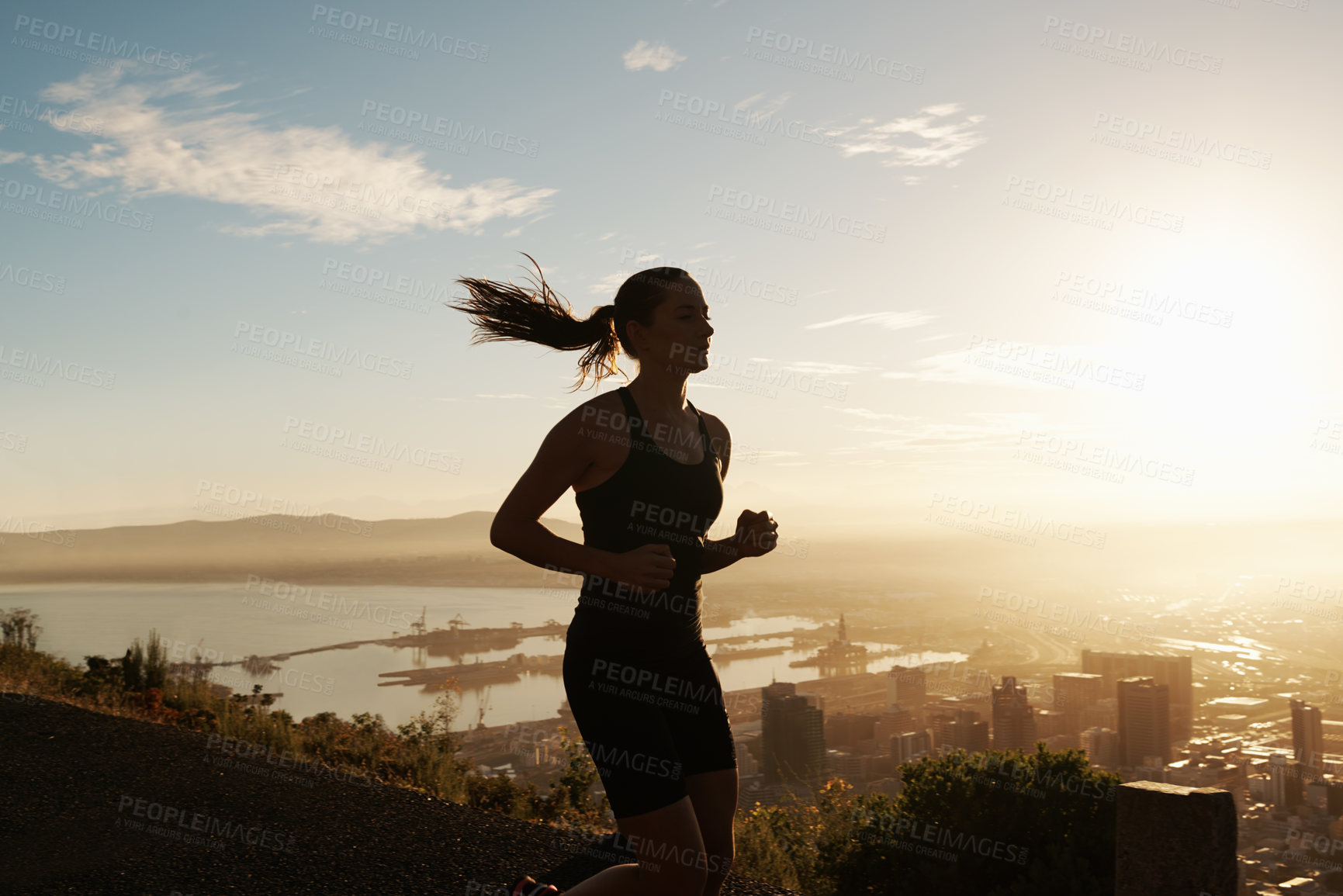 Buy stock photo Fitness, running and woman on hill at sunset for health, wellness and strong body development. Workout, exercise and girl runner on path in nature for marathon training, performance and challenge.
