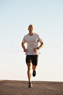 Buy stock photo Man, running in street and fitness outdoor, cardio and health, fresh air and training for marathon with sky background. Sport, exercise and athlete in city for workout with wellness and endurance