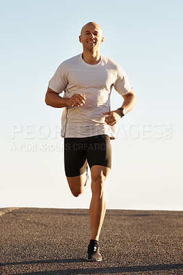 Buy stock photo Man, running in street and fitness for cardio, health and fresh air when training for marathon with sky background. Sports, exercise and athlete in portrait for workout, wellness and endurance