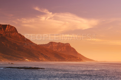 Buy stock photo Ocean, sunset and clouds on mountains by blue sky and outdoor travel for vacation in nature. Landscape, sea and sunlight on false bay with calm and seal island in cape town for tourist destination