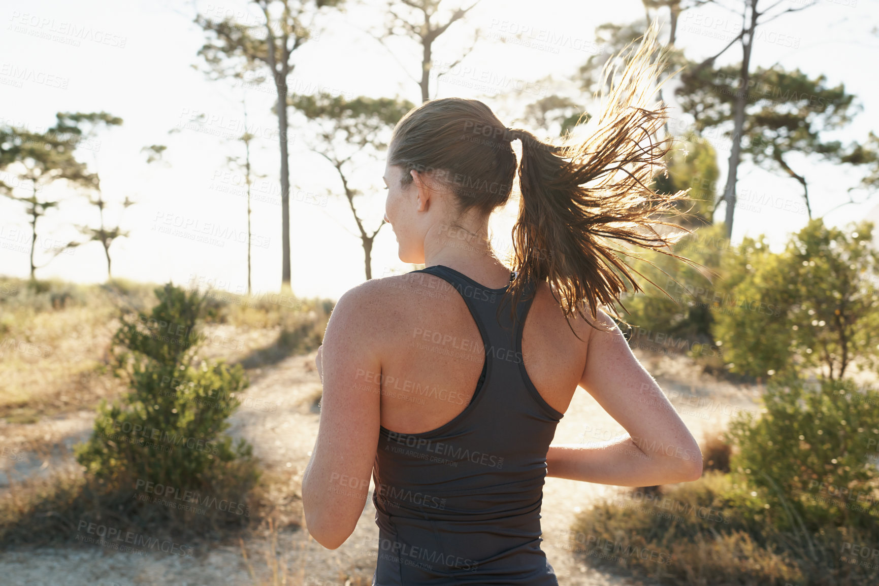 Buy stock photo Fitness, running and woman on path in forest for health, wellness and strong body development. Workout, exercise and girl runner on road in nature for marathon training, performance and challenge.