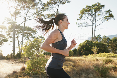 Buy stock photo Exercise, running and woman on path in mountain for health, wellness and strong body development. Workout, fitness and girl runner on road in nature for marathon training, performance and challenge.