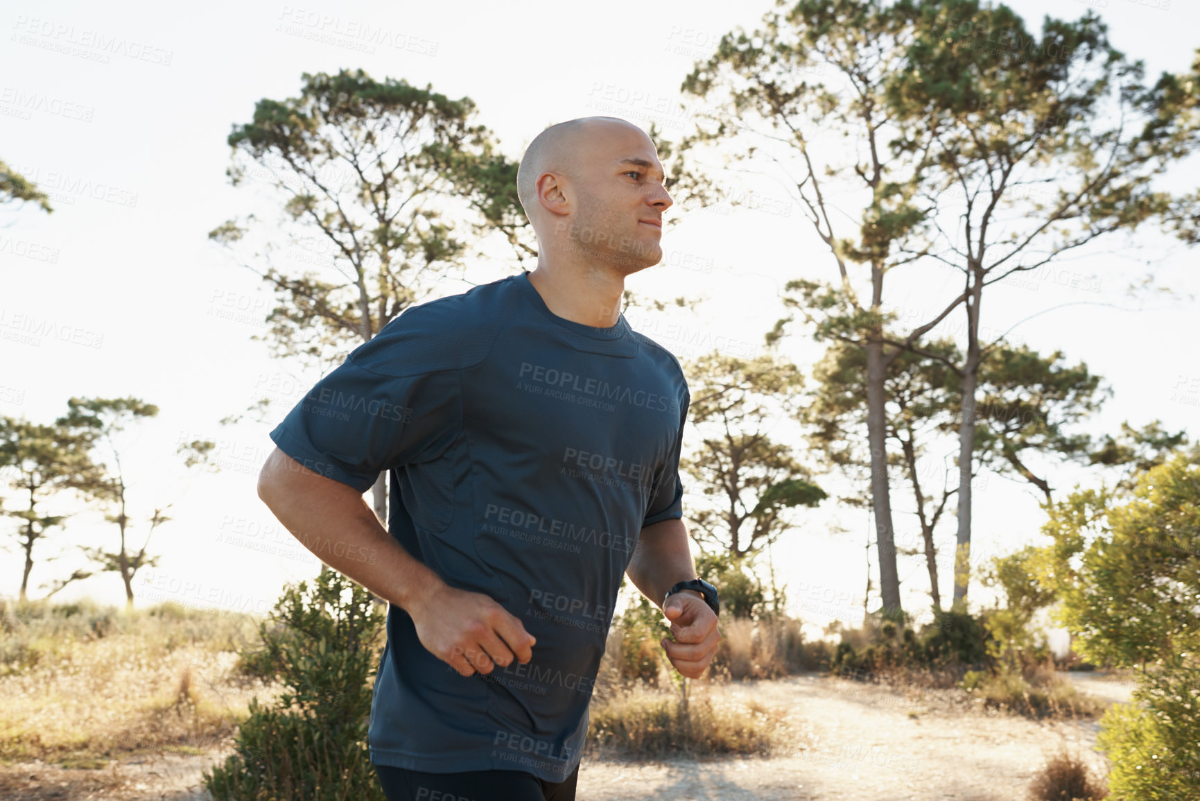 Buy stock photo Fitness, running and man on path in forest for health, wellness and strong body development. Workout, exercise and runner on road in nature for marathon training, performance and morning challenge.