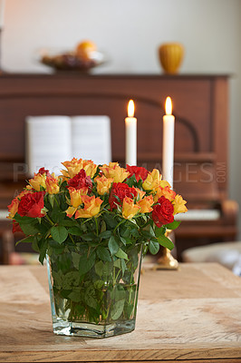 Buy stock photo Fresh bouquet of roses in a vase on table with a background of candles and a piano copyspace. A romantic gesture, proposal, birthday celebration, apology or gift on valentines day in an empty home 
