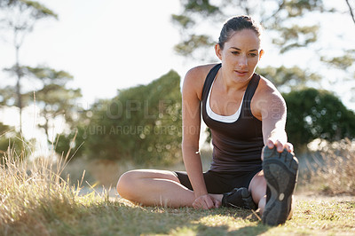 Buy stock photo Forest, stretching and woman on ground for fitness, workout and commitment to healthy body. Exercise, wellness and girl runner in muscle warm up for outdoor marathon training, performance and morning