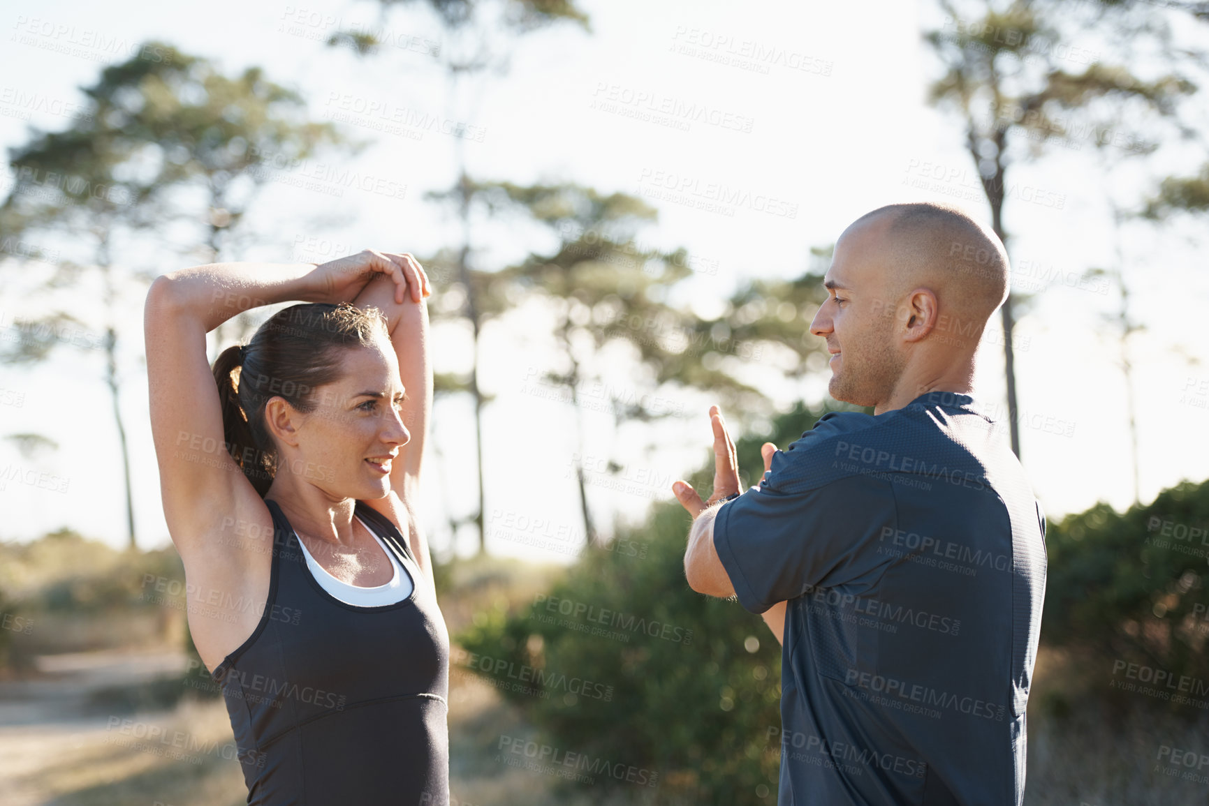 Buy stock photo Nature, stretching and couple in forest for fitness, workout and commitment to healthy body. Exercise, wellness and people in arm muscle warm up for outdoor training, performance and morning in woods