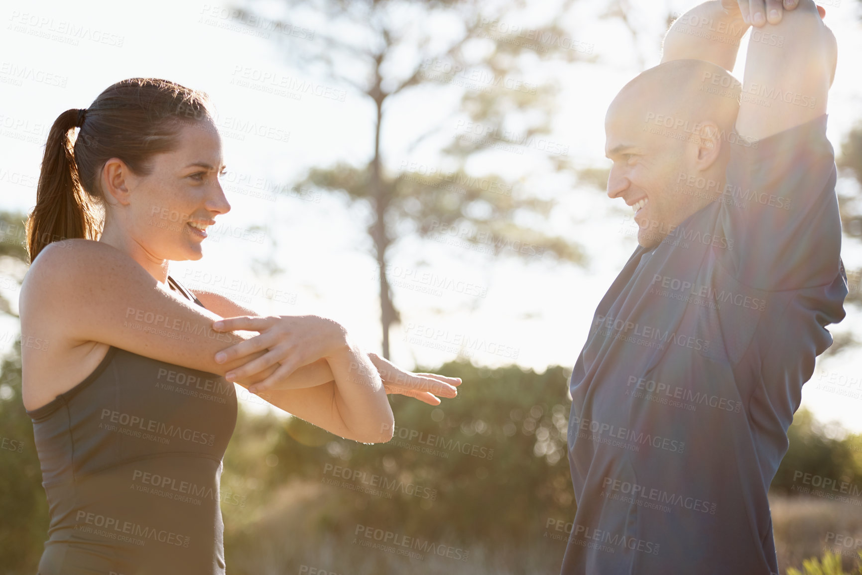 Buy stock photo Fitness, trees and couple stretching arms for workout, commitment and healthy body in nature. Exercise, man and happy woman in warm up for training, muscle and morning in woods with personal trainer.