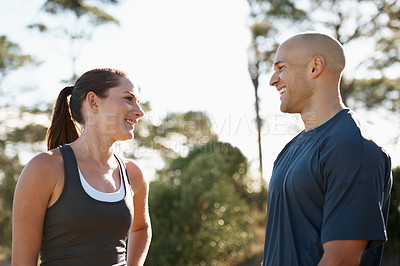 Buy stock photo Happy couple, fitness and break from workout, exercise or outdoor training together in nature. Man and woman with smile in rest or conversation for teamwork, hiking or trekking in health and wellness