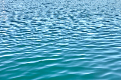 Buy stock photo Water background with ripples and copyspace. Closeup of fresh, calm blue ocean water at low tide. Zoom in on rippled water surface with unique patterns of motion. Zen, tranquil small meditative waves
