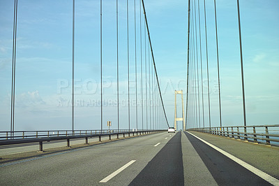 Buy stock photo Storebaelt suspension bridge in Denmark against blue sky background. Overpass road crossing for transport to link travel destination routes. Infrastructure and architecture design of famous landmark