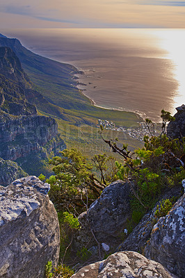 Buy stock photo Mountain, peak and landscape at sunset with sea, plants and perspective of nature in South Africa. Hill, countryside and aerial view of valley environment with biodiversity at ocean from hiking trail
