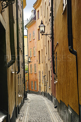Buy stock photo Travel, architecture and buildings on vintage alley with history, culture or holiday destination in Sweden. Vacation, old road and antique stone street in Stockholm with cobble path in ancient city