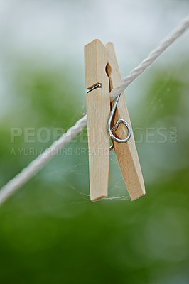 Buy stock photo Peg, rope and outdoor for clothes from laundry, clean and dry in nature with plastic clip of closeup. Washing, empty line and wooden tool to hang or pin cloth on wire, fasten and backyard AT house