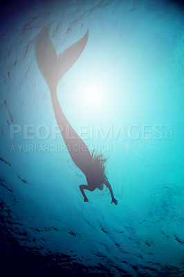 Buy stock photo A silhouette shot of a mermaid swimming in solitude in the deep blue sea - ALL design on this image is created from scratch by Yuri Arcurs'  team of professionals for this particular photo shoot