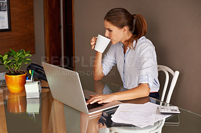 Buy stock photo An attractive young woman working from her home office