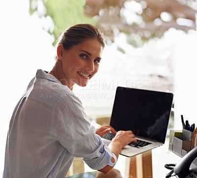 Buy stock photo An attractive young woman working from her home office