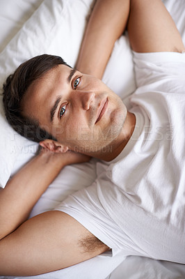 Buy stock photo Man, portrait and bed for peace, wellness and happy for rest in white top and bedroom for home and happy. Male person, relax and dreaming at house, calm and tired after day at work and taking nap 