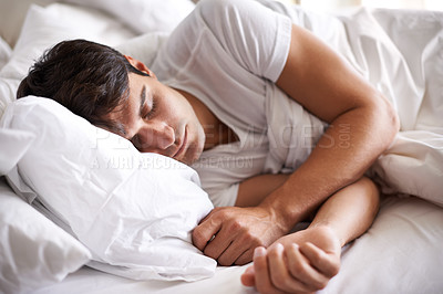 Buy stock photo Shot of a young man sleeping in bed