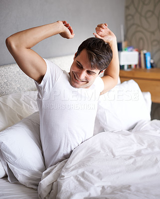 Buy stock photo Man, morning and stretch in bed, awake and smile for daily routine and house for rest and wellness. Male person, happy and bedroom in pajamas, and home in waking up and relaxing on Saturday day off