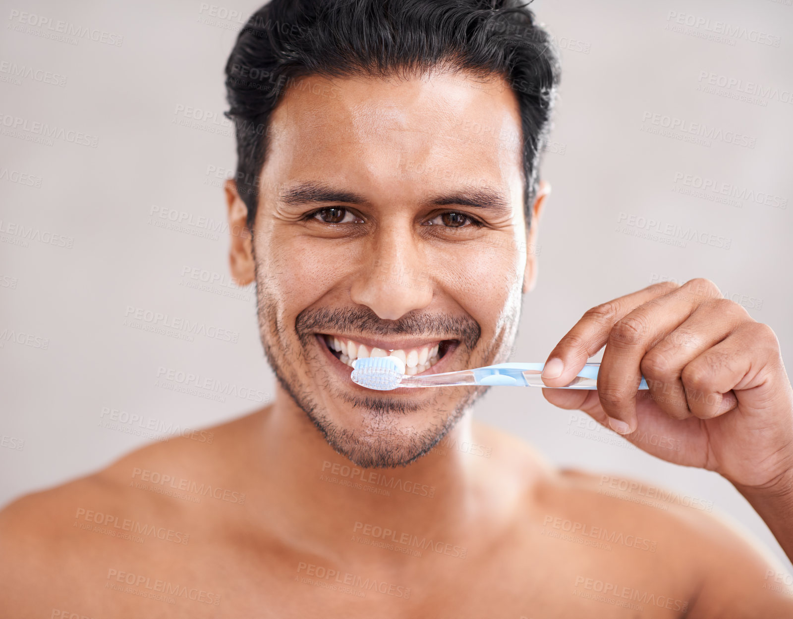 Buy stock photo Portrait of a handsome young man brushing his teeth