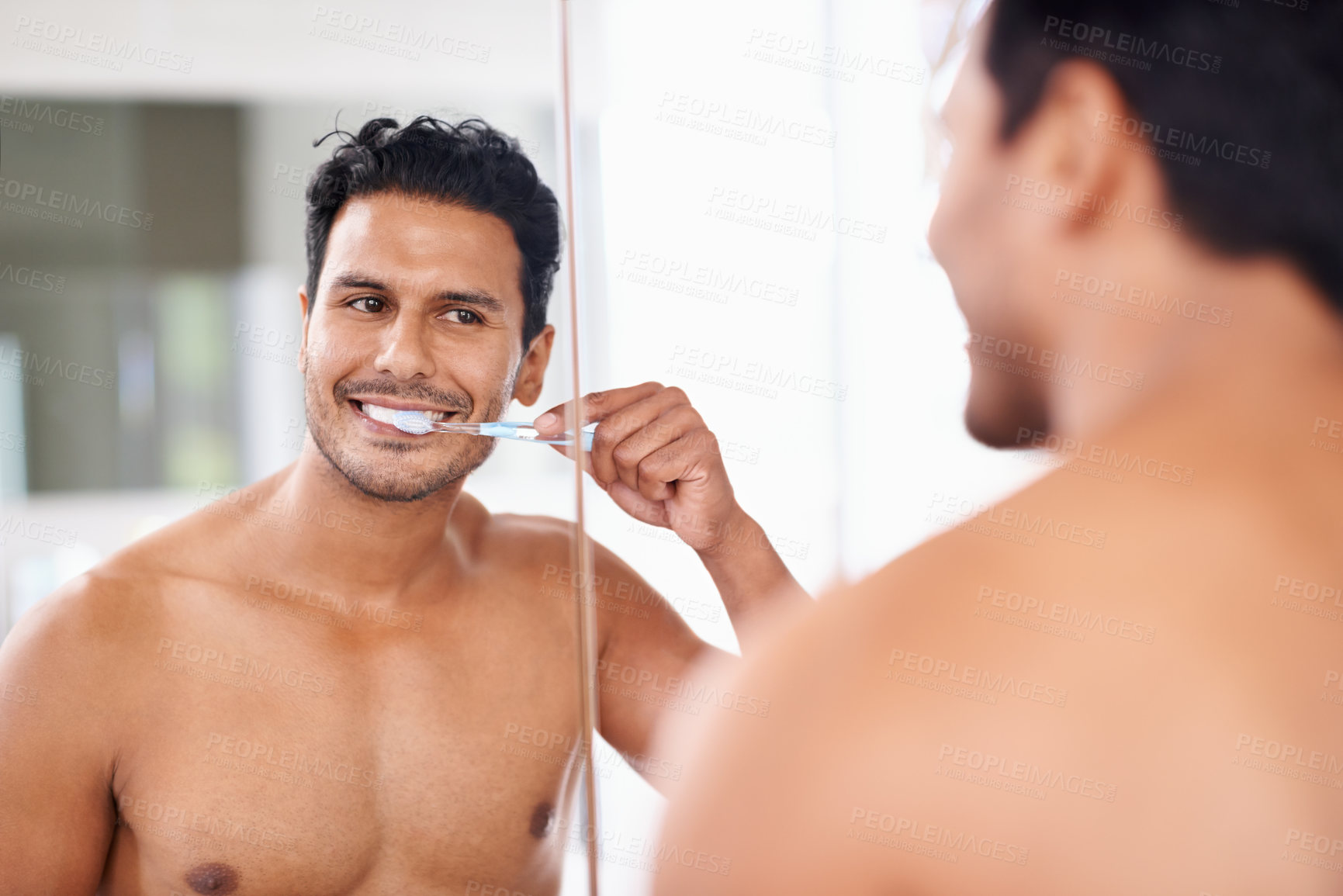 Buy stock photo Oral hygiene, mirror and man in bathroom for brushing teeth, self care and morning routine. Dental, smile and face of male person at home for wellness, toothbrush and cleaning with reflection.