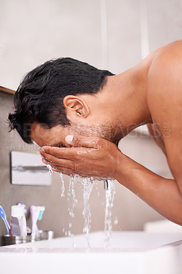 Buy stock photo Skincare, splash or man washing face in bathroom for self care, wellness or morning routine. Facial, cleaning or profile of male person at a basin for water, beauty or hydration, cosmetic or results