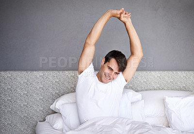 Buy stock photo Man, morning and smile in bed, house and stretching for daily routine and job for rest and wellness. Male person, happy and bedroom in pajamas, and home in awake and relaxing on Saturday day off