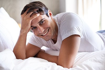 Buy stock photo Man, bed and smile in morning to relax, holiday and vacation in bedroom. Happy, day off and comfortable attractive male person, casual and rest for weekend break in apartment for waking up on sheet