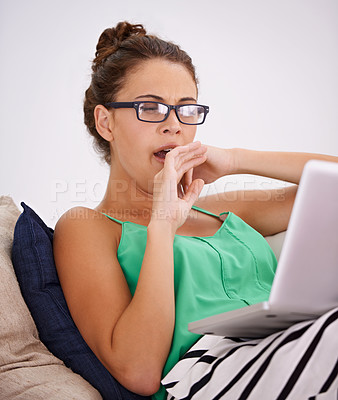 Buy stock photo Tired, woman and yawn on sofa laptop or working and exhausted in living room. Female person, casual outfit or computer and glasses in couch or lounge and face expression or sleepy in house or home