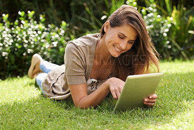 Buy stock photo Tablet, happiness and woman outdoor on grass, nature and garden for communication, technology and internet. Gen z female person, backyard and digital pad for social media, connectivity and browsing