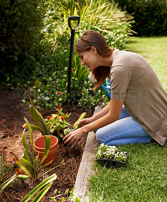 Buy stock photo Woman, flowers and gardening for agriculture in backyard with garden shovel, happiness and sustainability. Gardener, person and green fingers with plants and soil for growth or eco friendly hobby 