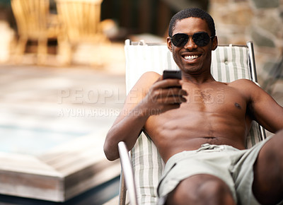 Buy stock photo Man, phone and relax on deckchair, happy and scroll on social media on summer holiday. Black male person, weekend and online for blog or app for chat on travel to Nigeria, vacation and outdoors