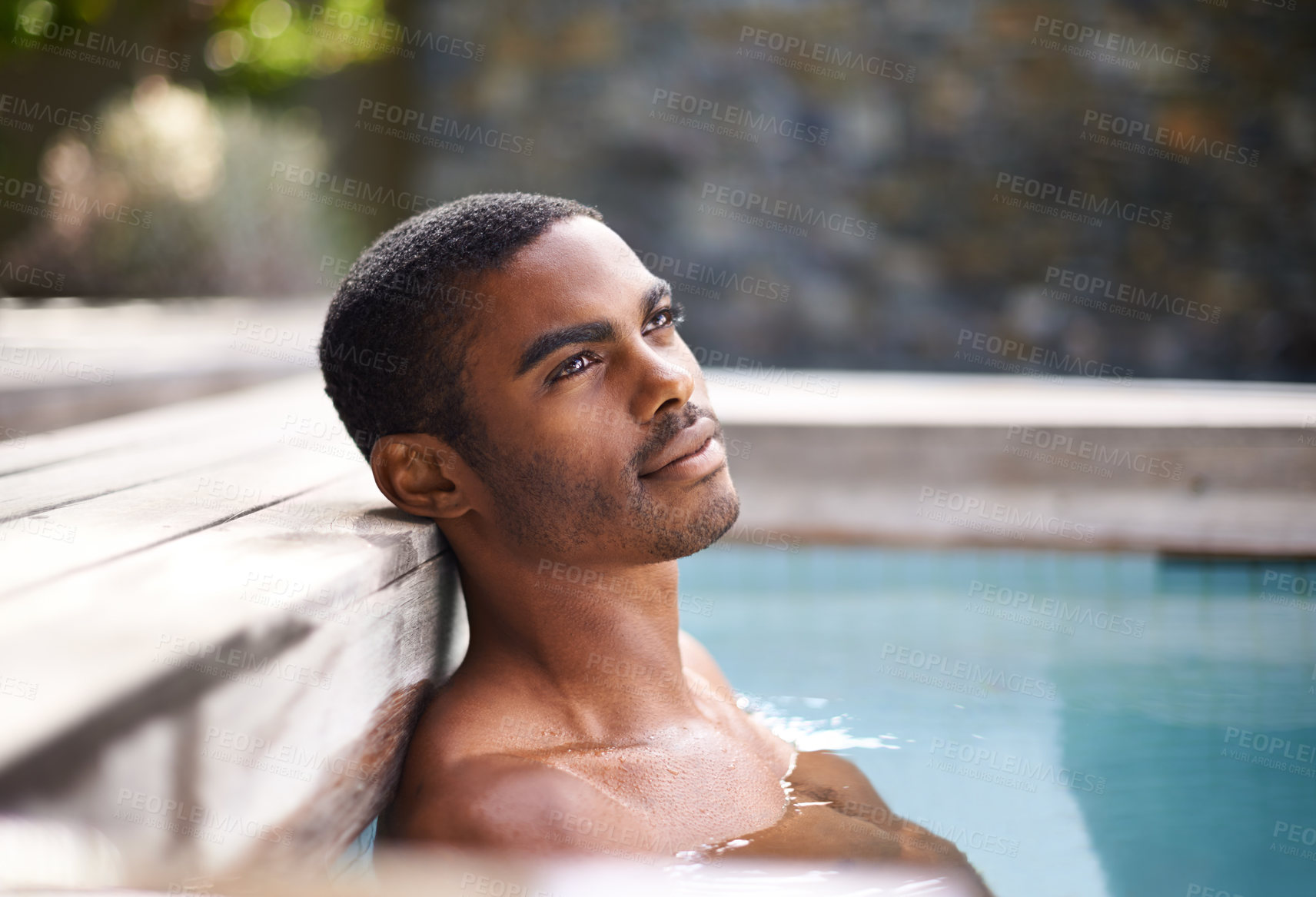 Buy stock photo Thinking, pool and water with African man, vacation and holiday outdoors to relax in sunshine. Summer, swimming and happiness for body wellness, calm person and weekend entertainment and ideas