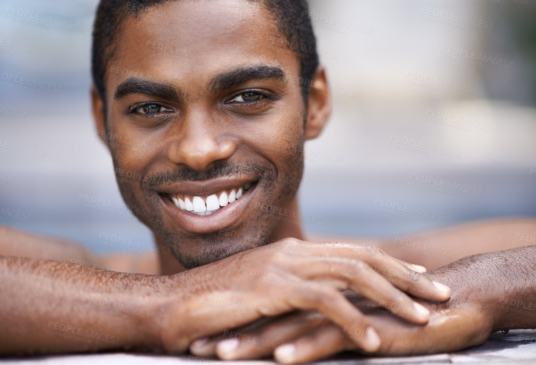 Buy stock photo Man, portrait and relax poolside, happy and swimming on weekend for having fun on summer holiday. Black male person, smile and calm or peace on travel to Nigeria, vacation and outdoors for leisure