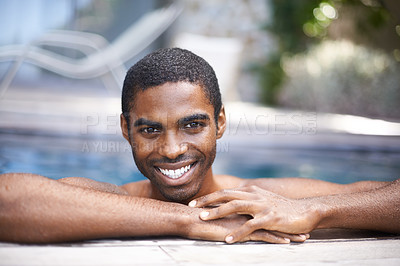 Buy stock photo Portrait of a handsome young man relaxing in a pool