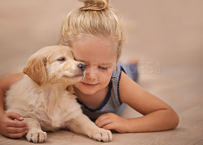 Buy stock photo Young girl hug her dog, relax with peace and calm at home with golden retriever puppy and child. Man's best friend, pet care and love with female kid and her domestic animal lying on wood floor