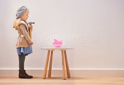 Buy stock photo Waiting, piggy bank and a girl with a hammer for money, savings and finance in a house. Investment, mockup space and little child standing with a tool to break a cash box for coins, banking or wealth